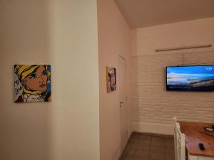 a living room with two paintings on the wall at Departamento ILLIA POP in Resistencia