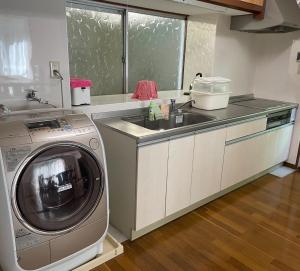 a kitchen with a washing machine and a sink at Watatsumi no Yado 1981 - Vacation STAY 55945v in Iki
