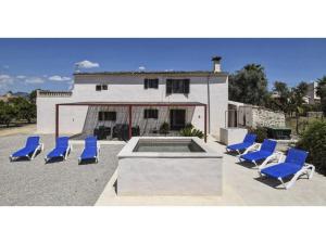 a group of blue chairs sitting in front of a house at Country house with panoramic views and small pool in Inca in Inca