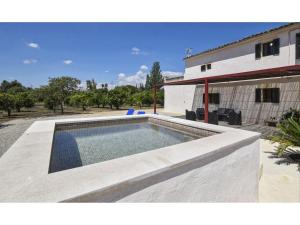 a swimming pool in front of a house at Country house with panoramic views and small pool in Inca in Inca