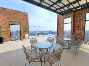 a patio with tables and chairs on a balcony at Luxury Apartment in zone 10 in Guatemala