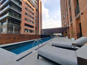 a swimming pool next to some tall buildings at Luxury Apartment in zone 10 in Guatemala
