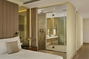 a bedroom with a glass shower and a bed at Penha Longa Resort in Sintra