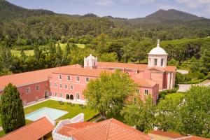 an aerial view of a large pink house with a pool at Penha Longa Resort in Sintra