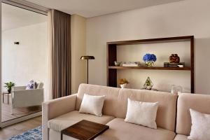 a living room with a couch and a table at Penha Longa Resort in Sintra