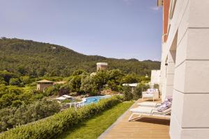 a balcony with lounge chairs and a swimming pool at Penha Longa Resort in Sintra