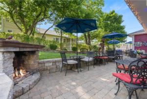 un patio con mesas y sillas y una chimenea al aire libre. en Historic Branson Hotel - Fisherman's Cove Room with King Bed - Downtown - FREE TICKETS INCLUDED, en Branson