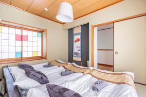 a bedroom with three beds with pillows on them at BISK PARK TOKYO - 4LDK Spacious House - Easy Access to Asakusa, Skytree area & Airport in Tokyo