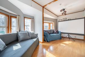 a living room with a couch and a screen at BISK PARK TOKYO - 4LDK Spacious House - Easy Access to Asakusa, Skytree area & Airport in Tokyo