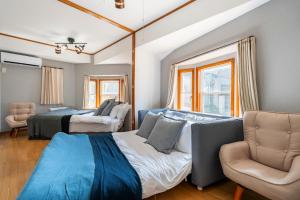 um quarto com 2 camas e um sofá em BISK PARK TOKYO - 4LDK Spacious House - Easy Access to Asakusa, Skytree area & Airport em Tóquio