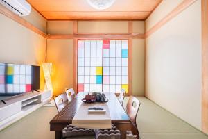 a dining room with a table and chairs and a stained glass window at BISK PARK TOKYO - 4LDK Spacious House - Easy Access to Asakusa, Skytree area & Airport in Tokyo