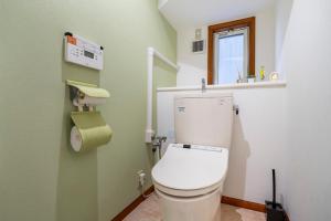 a bathroom with a white toilet with a window at BISK PARK TOKYO - 4LDK Spacious House - Easy Access to Asakusa, Skytree area & Airport in Tokyo