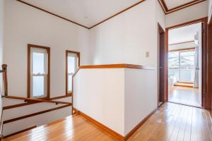 an empty room with a white wall and windows at BISK PARK TOKYO - 4LDK Spacious House - Easy Access to Asakusa, Skytree area & Airport in Tokyo