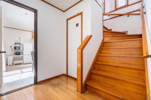 a staircase in a house with wooden floors and a mirror at BISK PARK TOKYO - 4LDK Spacious House - Easy Access to Asakusa, Skytree area & Airport in Tokyo
