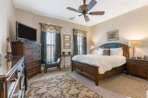 a bedroom with a bed and a flat screen tv at Historic Branson Hotel - Heritage Room with Queen Bed - Downtown - FREE TICKETS INCLUDED in Branson