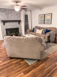 a living room with a couch and a fireplace at Beautiful 3-bedroom home next to Ft Bragg in Fayetteville