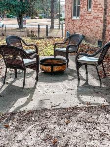 a group of three benches sitting around a fire pit at Beautiful 3-bedroom home next to Ft Bragg in Fayetteville