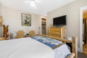 um quarto com uma cama e uma televisão de ecrã plano em Historic Branson Hotel - Hide-A-Way Room with Queen Bed - Downtown - FREE TICKETS INCLUDED em Branson