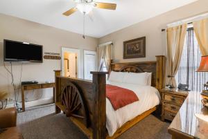 a bedroom with a bed and a flat screen tv at Historic Branson Hotel - Horseshoe Room with King Bed - Downtown - FREE TICKETS INCLUDED in Branson