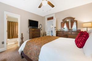 a bedroom with a large bed and a flat screen tv at Historic Branson Hotel - Notebook Room with Queen Bed - Downtown - FREE TICKETS INCLUDED in Branson