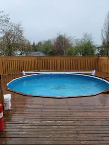 a pool on a deck with a wooden fence at Serene in Halifax