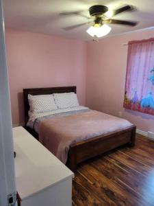 a bedroom with a bed and a ceiling fan at Serene in Halifax