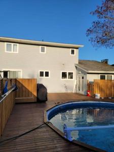 a backyard with a swimming pool and a house at Serene in Halifax