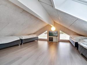 a room with three beds and a tv in it at Luxury Retreat by Houstrup - By Traum Ferienwohnungen in Nørre Nebel +33 photos