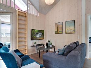 a living room with two blue couches and a table at Luxury Retreat by Houstrup - By Traum Ferienwohnungen in Nørre Nebel