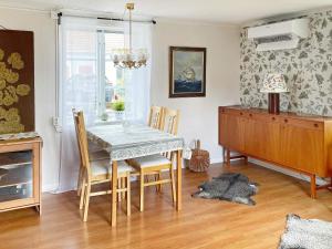 a dining room with a table and chairs at Holiday home Lekeryd II in Lekeryd