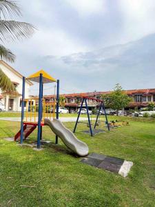 a playground with a slide in a park at Homestay Desa (Bukit Baru, Melaka) in Melaka