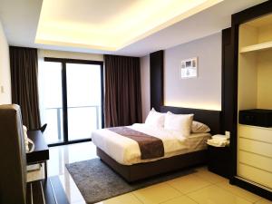 a hotel room with a bed and a large window at Genting SkySmokyColdInn3R2B AT Ion Delemen in Genting Highlands +51 photos