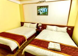 Postel nebo postele na pokoji v ubytování Cherry Hotel