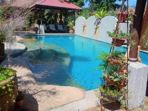 a swimming pool in the middle of a resort at Baan Tropicana in Mae Nam