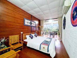 1 dormitorio con 1 cama y pared de madera en Bac Ha Boutique Homestay, en Bắc Hà