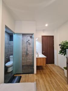 a bathroom with a shower and a toilet and a sink at 462 đường Bưởi, Tây Hồ, Hà Nội in Hanoi