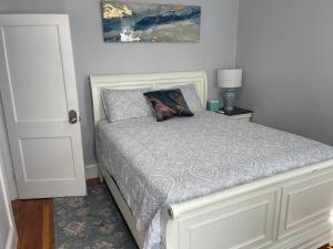 a bedroom with a white bed with a pillow on it at Boston Luxury Condo Style Rooms in Boston