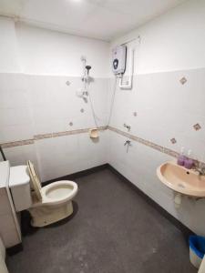 a bathroom with a toilet and a sink at KK City Api Api Apartment beside Centre Point by JR Homestay in Kota Kinabalu