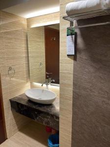 a bathroom with a sink and a mirror at Panbil Residence Apartment Batam in Kangboi