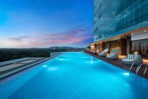 a swimming pool in the middle of a building at Apartment Panbil with Gym & Pool #Unit 603 in Nagoya