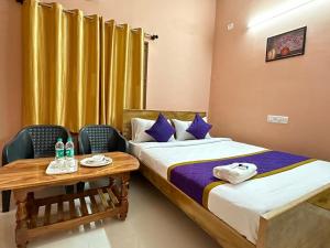a hotel room with two beds and a table at Vbh Inn- Affordable and Budget Friendly in Jigani