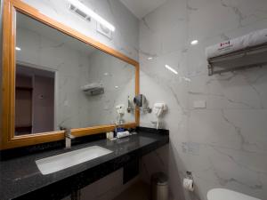 a bathroom with a sink and a mirror at MIRAFLORES CITY HOTEL in Lima