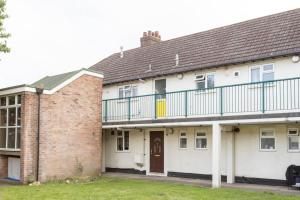 a house with a balcony on top of it at cosy 1 bedroom flat near Barking town centre in Barking