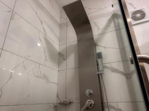 a shower with a glass door in a bathroom at MIRAFLORES CITY HOTEL in Lima