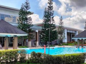 a swimming pool in front of a building at Unit 1005 Tower B Cool Suites at Wind Residences in Tagaytay