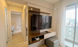 a living room with a flat screen tv on a wall at Exclusivo departamento piscina tempera vistamar in Lima