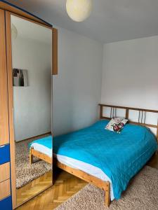 a small bedroom with a bed and a mirror at Apartament Central Plaja Modern in Constanţa