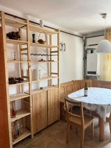 a dining room with a table and a shelf at Apartament Central Plaja Modern in Constanţa