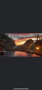 a view of a river with a sunset in the background at Giasemi apartments in Karistos