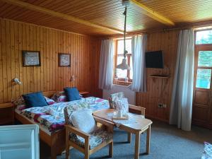 a bedroom with a bed and a table and chairs at Privát Majo - Váš oddych na Liptove in Liptovský Mikuláš